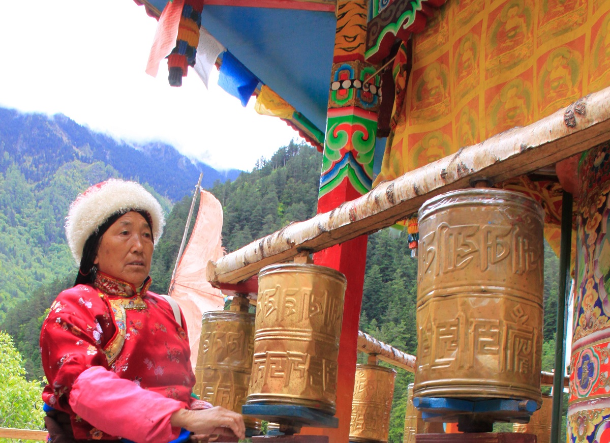 A women with prayer wheels at a traditional village in China.
