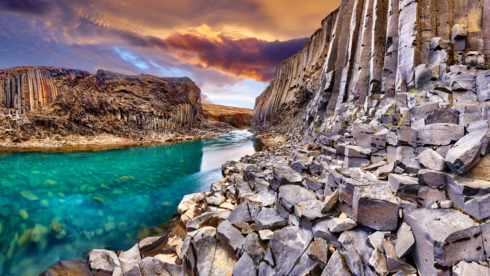 Studlagil basalt canyon, Jokulsa a Dal River. Iceland, Europe. One of the most wonderfull hidden place and nature sightseeing. Famous tourist landscape with basalt rock formations. Travel postcard.